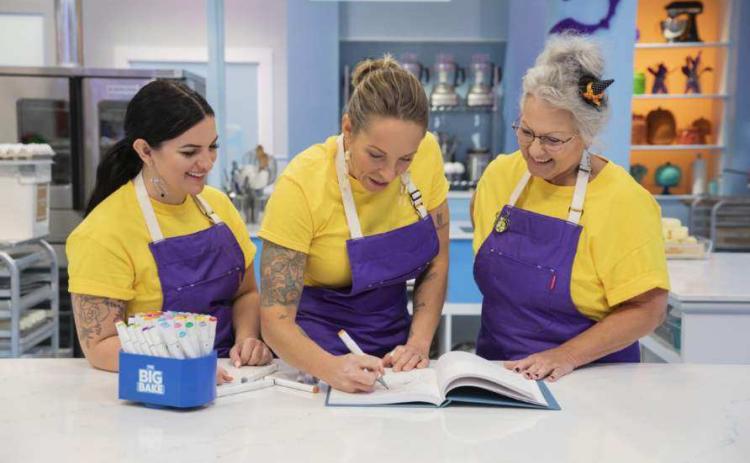 Lake City cake artist Amy Strickland (center) draws a design on ‘The Big Bake: Halloween’ with her teammates Keesha Fundora of Mayo (left) and Letricia Ervin of Lake City. (COURTESY)