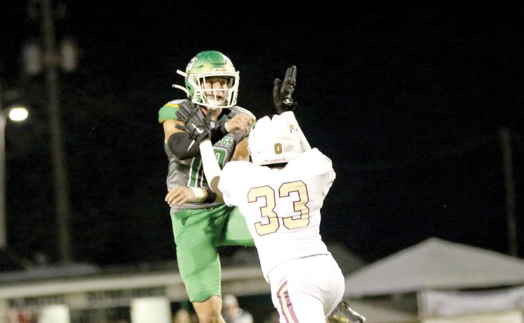 Suwannee quarterback Kodi Lang throws a pass while being pressured by Jordan McDonald last Friday. (JAMIE WACHTER/Lake City Reporter)