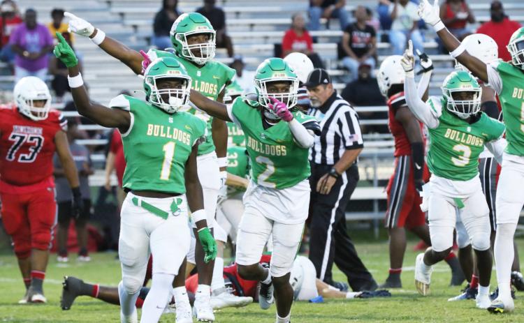 Suwannee defensive back PJ Davis (1), Amarion Rojas (2) and defensive end Ja’Darius Cherry (back) celebrate after their team’s fumble recovery against Munroe last Friday. (JAMIE WACHTER/Lake City Reporter)