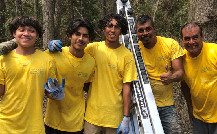 Daniel Mora, Elvis Reynolds, Ammon Reyes, Virginio Mora and Martin Mora are all smiles after helping clear debris from a group of homes for disabled individuals. (COURTESY)