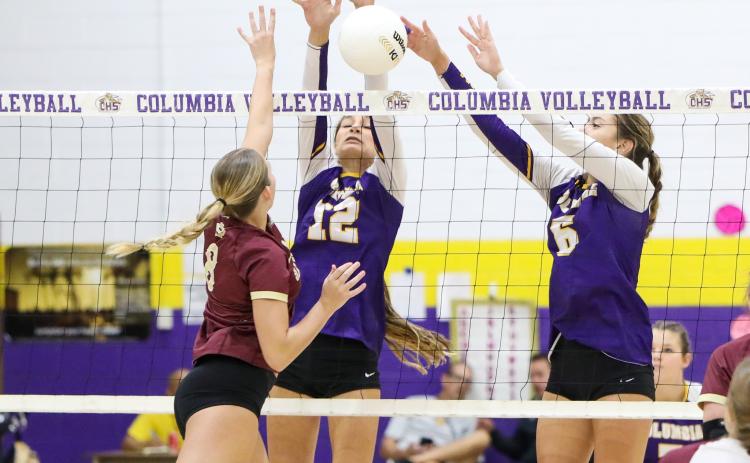 Columbia’s Kayla Goodloe (12) and Sinei Wood (6) attempt to block a shot by Oak Hall hitter Ave Scorpio on Tuesday night. (BRENT KUYKENDALL/Lake City Reporter)