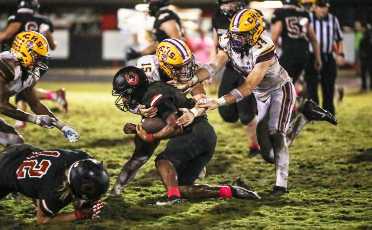 Columbia linebacker Tyson Yaxley (15) and defensive lineman Kyten Davis (34) make a tackle against Middleburg on Friday. (BRENT KUYKENDALL/Lake City Reporter)