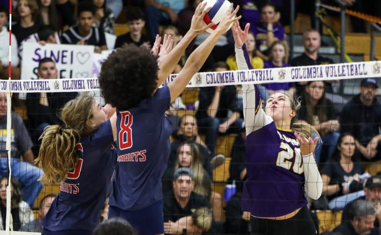Columbia middle hitter Cassidy O’Neal gets blocked by Vanguard middle hitter Lillian Hart during Tuesday’s District 2-5A semifinal. (BRENT KUYKENDALL/Lake City Reporter)