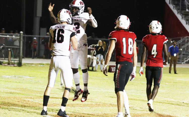 Fort White receiver Najeeb Smith celebrates with receiver Garrett Brady after Brady scored a touchdown against Hilliard on Friday night. (MORGAN MCMULLEN/Lake City Reporter)