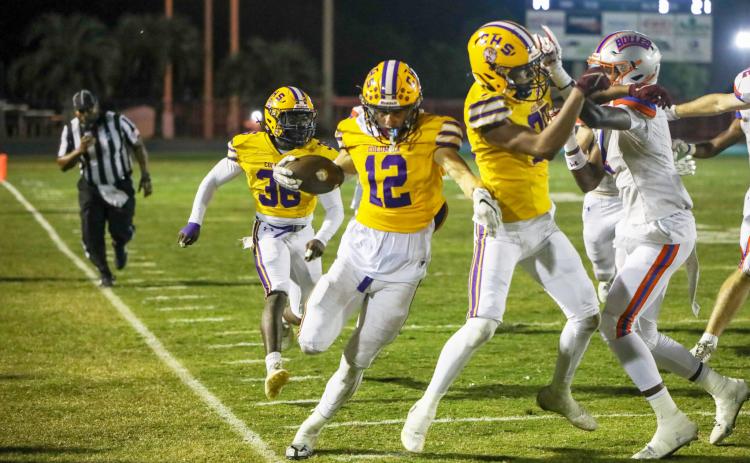 Columbia receiver Camdon Frier (12) tip-toes the sideline after a catch against Bolles on Friday. (BRENT KUYKENDALL/Lake City Reporter)