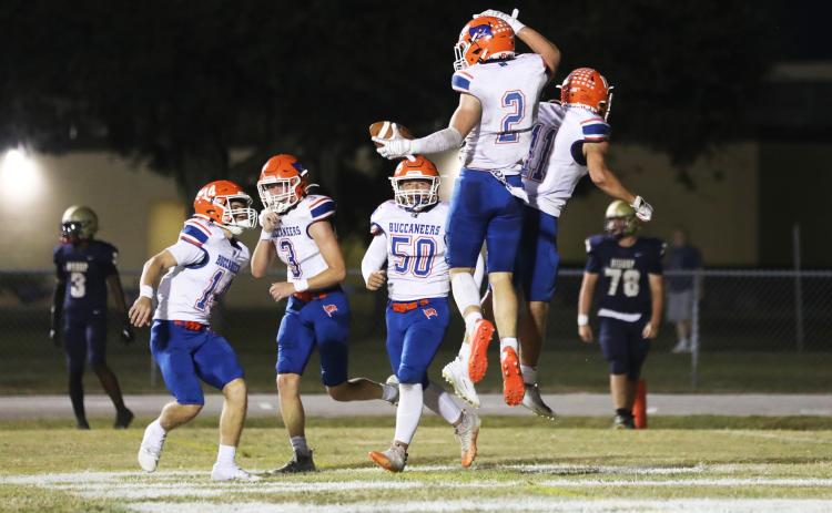 Branford running back Trevor Maddox (2) celebrates with teammates after scoring a touchdown against Bishop McLaughlin Catholic on Friday. (ERIN ROBERTS/Special to the Reporter