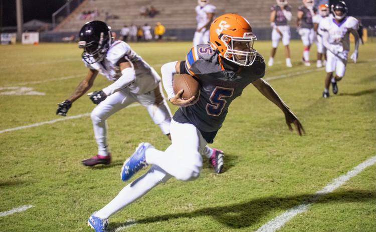 Branford receiver Kyshaun Veasey runs past a Hollis Christian Academy defender on Friday. (ERIN ROBERTS/Special to the Reporter)
