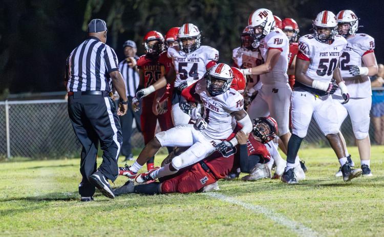 Lafayette defensive back Tywan Williamson (9) tackles Fort White running back Dakota Fisher (1) last Friday. (JACK HOWDESHELL/Special to the Reporter)