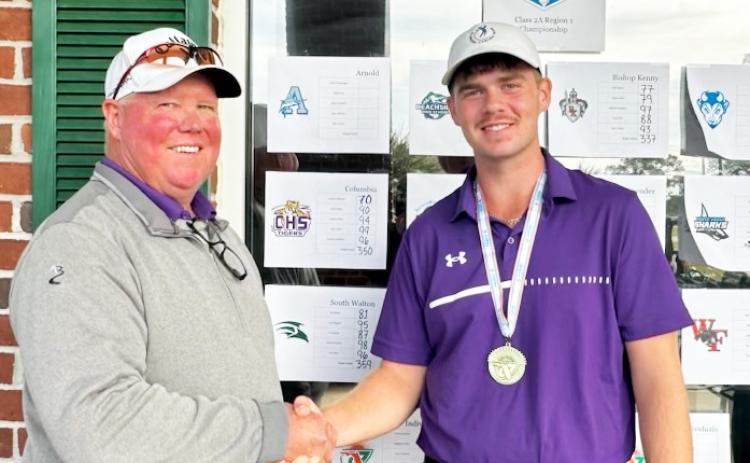 Columbia head coach Sherman Reed (left) shakes hands with Columbia golfer Connor Williams (right) after Williams won the Region 1-2A title on Tuesday. (COURTESY)
