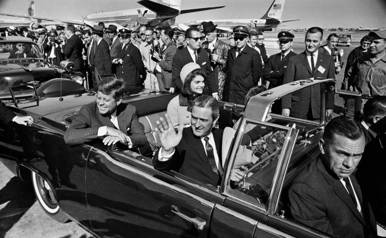 President John F. Kennedy (back left), Jacqueline Kennedy (back right), begin the motorcade from Love Field to downtown Dallas on Nov. 22, 1963. Texas Gov. John Connally is waving. (TOM DILLARD/Dallas Morning News/TNS/file)