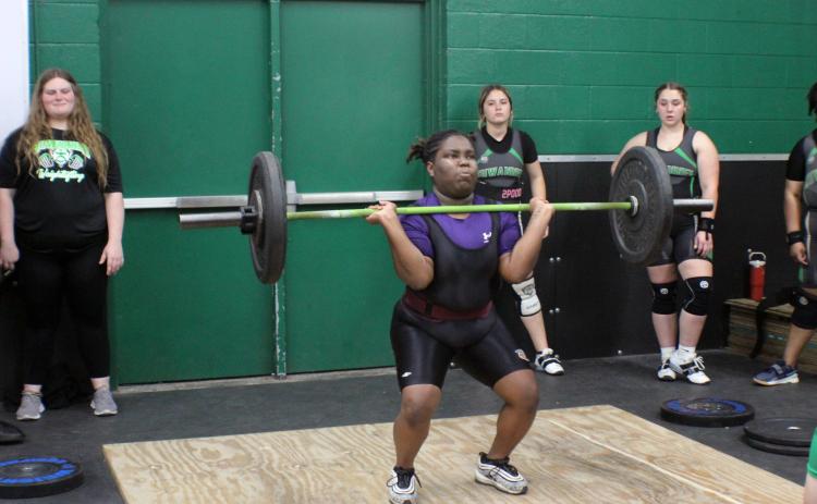 Columbia lifter Amaya Hawkins performs the clean and jerk during Monday's meet against Suwannee. (COURTESY)