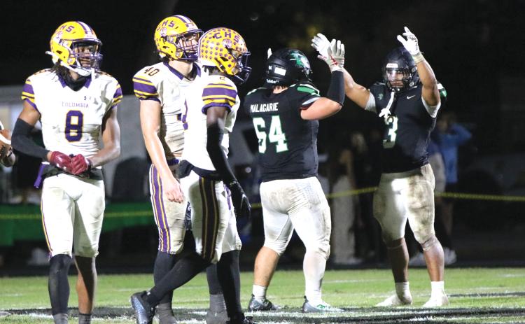 Choctawhatchee running back Cole Tabb (3) celebrates after scoring a touchdown as defensive back Markeyon Moore (8), defensive end Ayden Phillips (40) and defensive back Lequawn Johnson (2) look on during Friday's Region 1-3S quarterfinal. (JORDAN KROEGER/Lake City Reporter)