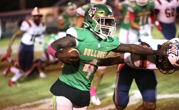 Suwannee running back Marquavious Owens stiff arms a Wakulla defender last Friday. (PAUL BUCHANAN/Special to the Reporter)