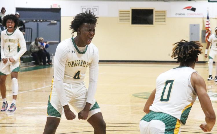 FGC forward Ty’jahn Wright (4) and guard Antewan Webber (1) celebrate after a dunk by Oakley Lewis (0) against Polk State College on Wednesday. (JORDAN KROEGER/Lake City Reporter)