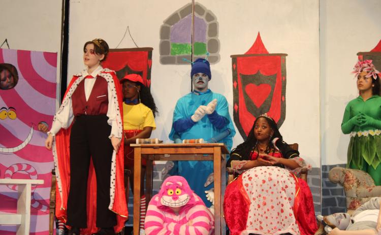Connor Sanders (standing left), who is portraying the character of King of Hearts in Columbia High School’s production of Alice At Wonderland, rehearses a scene on Monday afternoon. (TONY BRITT/Lake City Reporter)