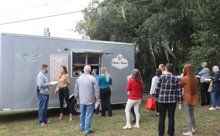 A line waits at the Cluckin’ and Truckin’ food truck at The Foundation for Florida Gateway College Giving Day campaign event Tuesday. (TONY BRITT/Lake City Reporter)