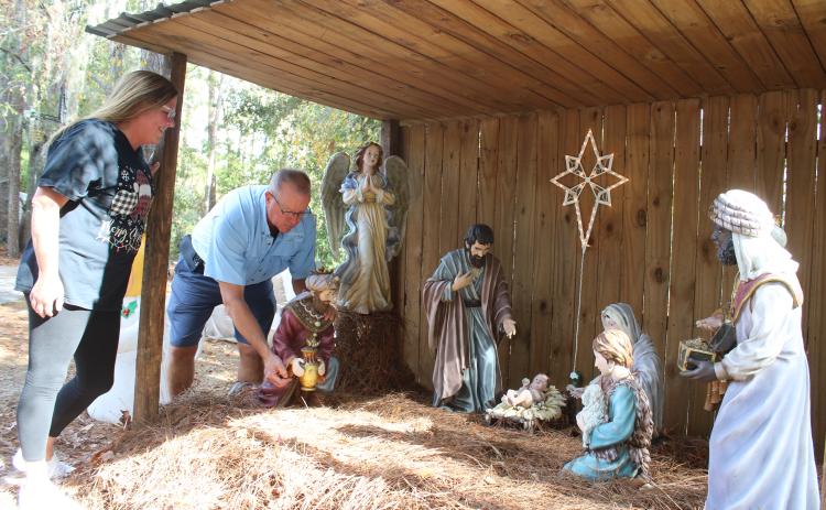 Brad and Lorrie Wheeler finish setting up a nativity scene in their yard Monday. The Wheelers’ Christmas display has become a community draw for the past 27 years at 197 NW Brookside Court. The display officially begins every year on Thanksgiving night. (TONY BRITT/Lake City Reporter)