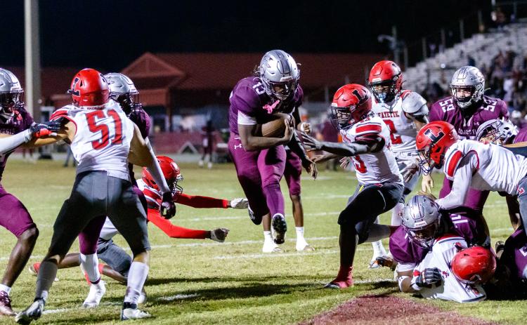 Madison County running back Ryshard Miller leaps past the Lafayette defense into the end zone for a touchdown during Friday’s Region 3-1R semifinal. (JACK HOWDESHELL/Special to the Reporter)