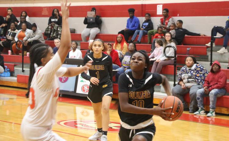 Columbia guard Ayesha Broxey (10) drives to the basket as guard Mariah Cox looks on from the background in the first half of Wednesday’s win over Santa Fe. (MORGAN MCMULLEN/Lake City Reporter)