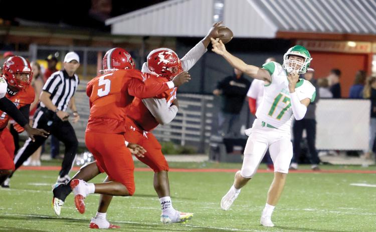 A Bradford defender deflects the ball directly out of Suwannee quarterback Koy Frier’s hand Friday night. Tornadoes linebacker Duke Lewis (5) intercepted the ball and returned it for a touchdown. (PAUL BUCHANAN/Special to the Reporter)