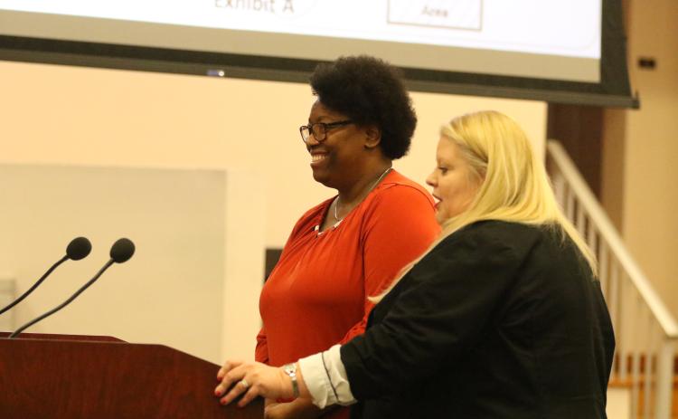 Van Brown, the county’s new economic development specialist, smiles as Economic Development Director Jennifer Daniels introduces her at Thursday’s County Commission meeting. (JAMIE WACHTER/Lake City Reporter)