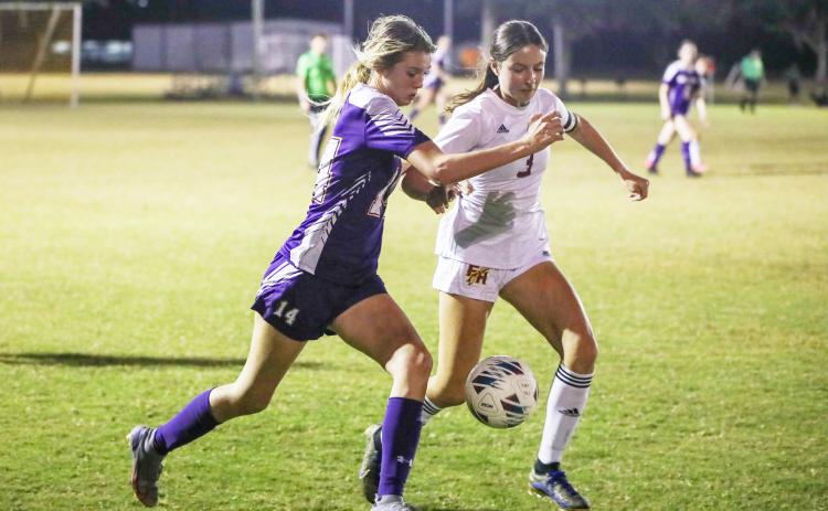 Columbia’s Mia Brasel fights for possession of the ball with Florida High’s Olivia Talevich on Friday. (BRENT KUYKENDALL/Lake City Reporter)