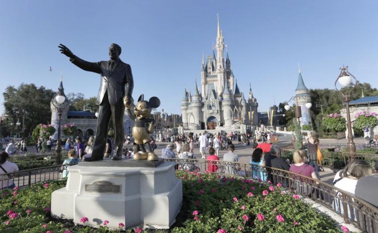 A statue of Walt Disney and Mickey Mouse appears in front of the Cinderella Castle at the Magic Kingdom theme park at Walt Disney World in Lake Buena Vista. (JOHN RAOUX/Associated Press)