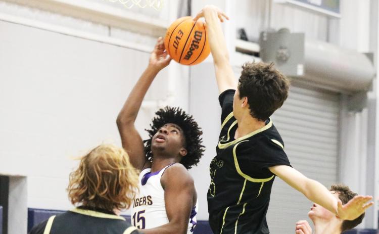 Nease center Jack Sullivan (right) blocks Columbia forward Zavian Douglas’ shot during the Hitchcock’s Challenge on Wednesday. (JORDAN KROEGER/Lake City Reporter)
