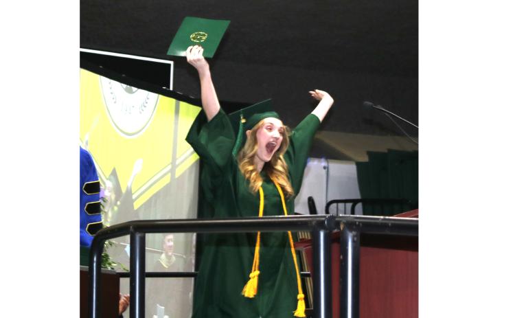 Zoey Isabellle Nettles shows her excitement after getting her college diploma Thursday night during the Florida Gateway College graduation ceremony. (TONY BRITT/Lake City Reporter)