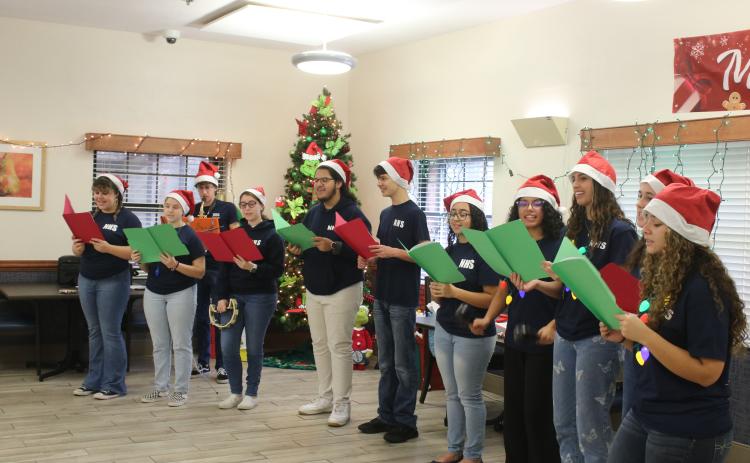 Fort White High School National Honor Society members sing Christmas carols while visiting the Robert H. Jenkins Veterans Domiciliary on Sunday afternoon. (TONY BRITT/Lake City Reporter)