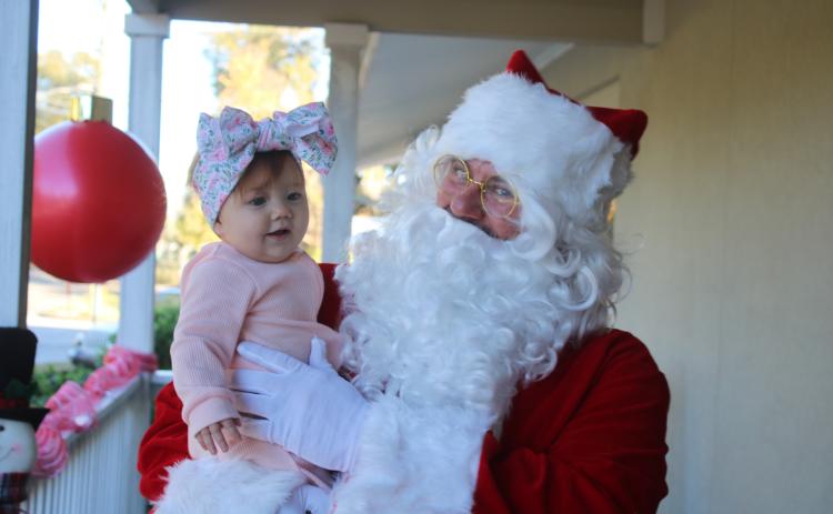 Santa Claus visits with Adeline Sage, six months old, on Tuesday afternoon at the Pregnancy Care Center. (TONY BRITT/Lake City Reporter)