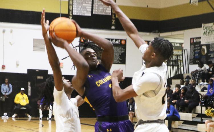 Columbia guard Zamarion Jones drives to the basket between two Buchholz defenders on Tuesday night. (MORGAN MCMULLEN/Lake City Reporter)