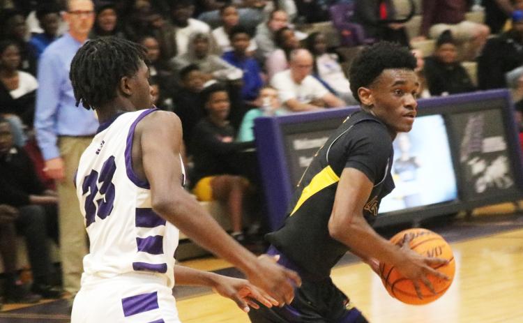 Columbia guard Bobby Wilson looks for a driving lane while being defended by Gainesville guard Willie Brooks on Tuesday. (JORDAN KROEGER/Lake City Reporter)