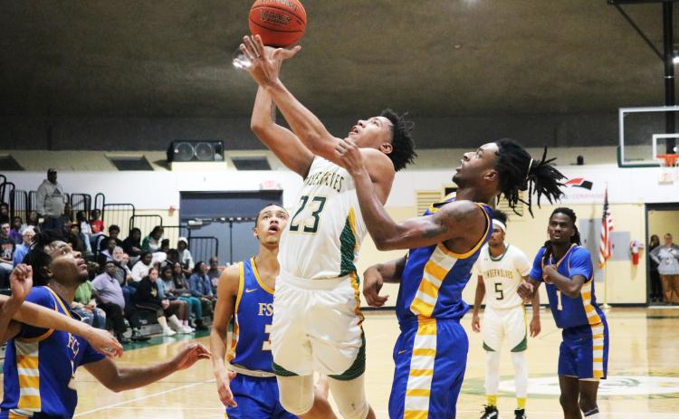 FGC forward Joseph Mitchell gets up a shot against the FSCJ defense on Wednesday night. (JORDAN KROEGER/Lake City Reporter)