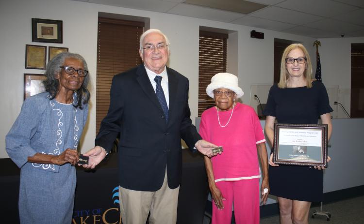 Corine D. Lofton (from left) stands with Mayor Stephen Witt as he gives her and Francena Williams Robinson Harris a ceremonial key to the city during a Friday evening ceremony where Audrey Sikes (far right) received a certification of recognition during a ceremony at Olivet Missionary Baptist Church on Friday. (TONY BRITT/Lake City Reporter)