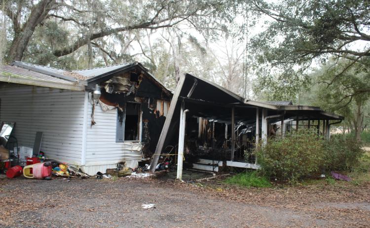 Columbia County firefighters pulled a woman and her two dogs from a mobile home fire on King Street on Tuesday morning. The woman was airlifted to an area hospital. (TONY BRITT/Lake City Reporter)