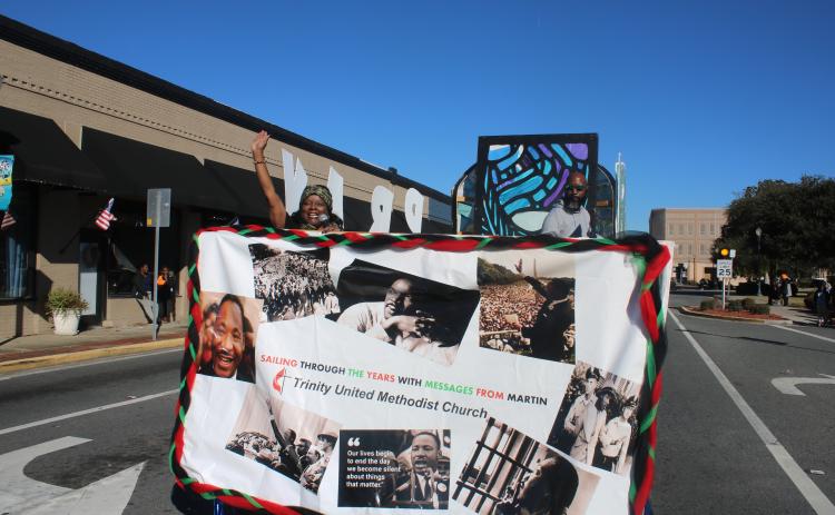 Pamela Green, the pastor at Trinity United Methodist Church, waves from the church’s entry in last year’s Martin Luther King Jr. Day parade. (FILE)