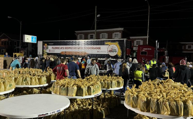 Volunteers help prepare an estimated 32,532 pounds of food early Saturday morning for the Farm Share distribution at the Lake City Police Department. (COURTESY LAKE CITY POLICE DEPARTMENT)