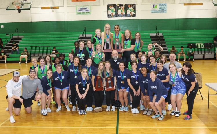 District 4-1A champion Suwannee and district runner-up Maclay pose with their district trophies on Friday. (PAUL BUCHANAN/Special to the Reporter)