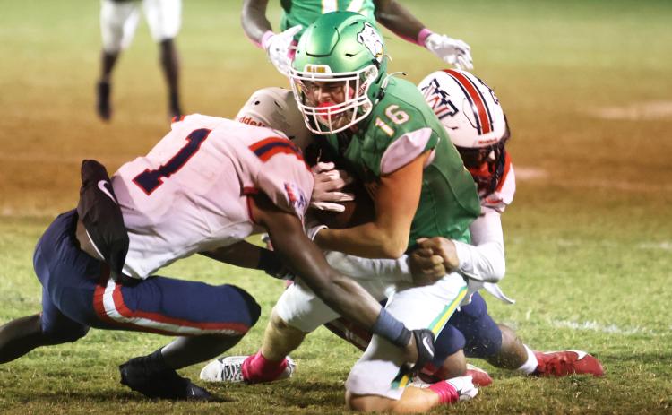 Suwannee receiver Noah Lopez is tackled by a pair of Wakulla defenders during last season’s meeting. Suwannee and Wakulla will be in the same district again next season. (PAUL BUCHANAN/Special to the Reporter)