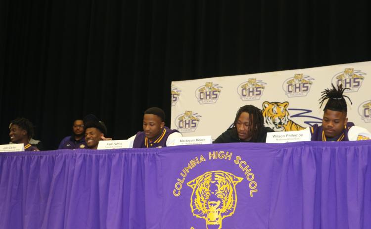 Columbia football players D'Mari Bruce (from left), Jalin Carter, Kani Fulton, Markeyon Moore and Wilson Philemon signed their letters of intent to play college football on Wednesday. (JAMIE WACHTER/Lake City Reporter)