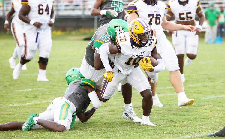 Columbia receiver Zamarion Jones tries to escape a tackle from Suwannee linebacker Lan’darren Gross during last season’s Preseason Classic. The teams will meet in the season opener this year on Aug. 23. (BRENT KUYKENDALL/Lake City Reporter)