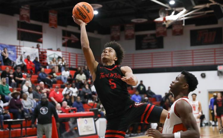 Fort White guard Tafari Moe rises for a shot while defended by Hawthorne guard CJ Ingram during the District 6-1A semifinals on Feb. 8. (BRENT KUYKENDALL/Lake City Reporter)