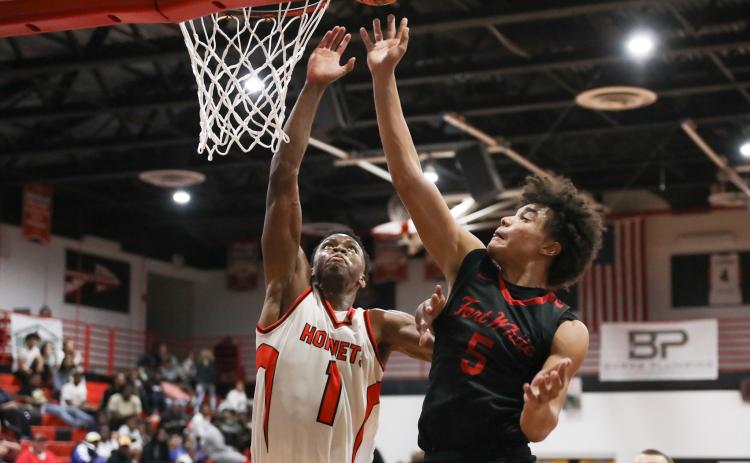 Fort White guard Tafari Moe gets off a shot while being defended by Hawthorne guard CJ Ingram during Thursday's District 6-1A semifinal. (BRENT KUYKENDALL/Lake City Reporter)