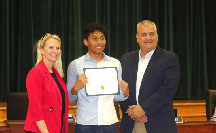 Columbia High junior Nathan Chowdhury was recognized by School Board Chair Dana Brady-Giddens (left) and Superintendent Lex Carswell (right) as the district’s Sunshine State Scholar at Tuesday’s board meeting. (JAMIE WACHTER/Lake City Reporter)