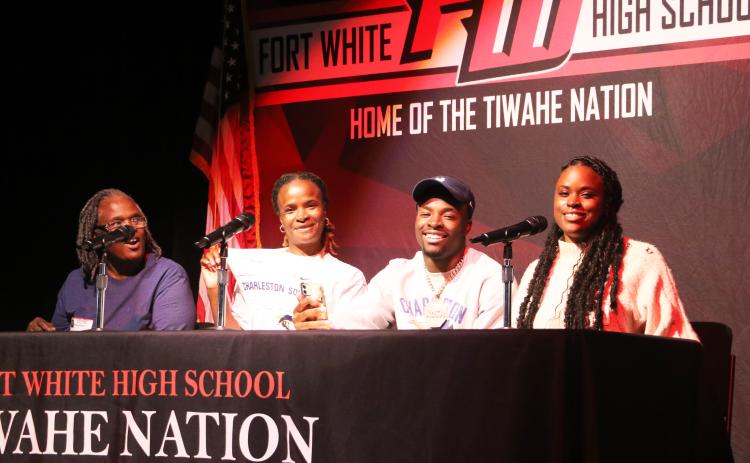 Fort White running back Dakota Fisher (second from right) signed his letter of intent to play football at Charleston Southern University on Wednesday flanked by his (from left) grandmother Shirley Adams, mother Tonya Fisher and sister Jamisha Walls. (MORGAN MCMULLEN/Lake City Reporter)