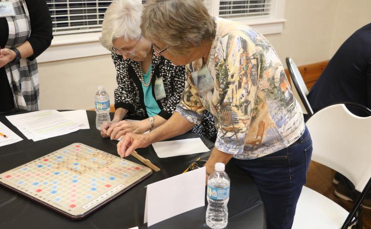 Marilyn Hamm (left) and Marcia Kazmierski look over their board in last year’s Lake City Garden Club Scrabble Tournament. (FILE)