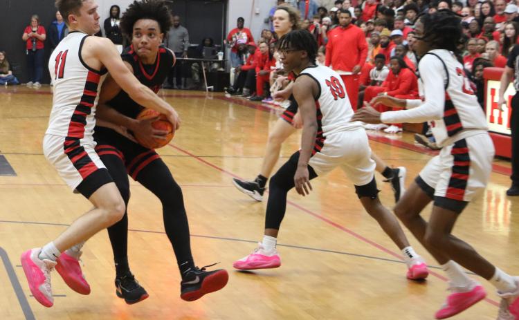 Fort White guard Tafari Moe gets tied up with Hilliard’s Brandyn Seldomridge in the fourth quarter of Tuesday’s Region 3-1A championship. (MORGAN MCMULLEN/Lake City Reporter)