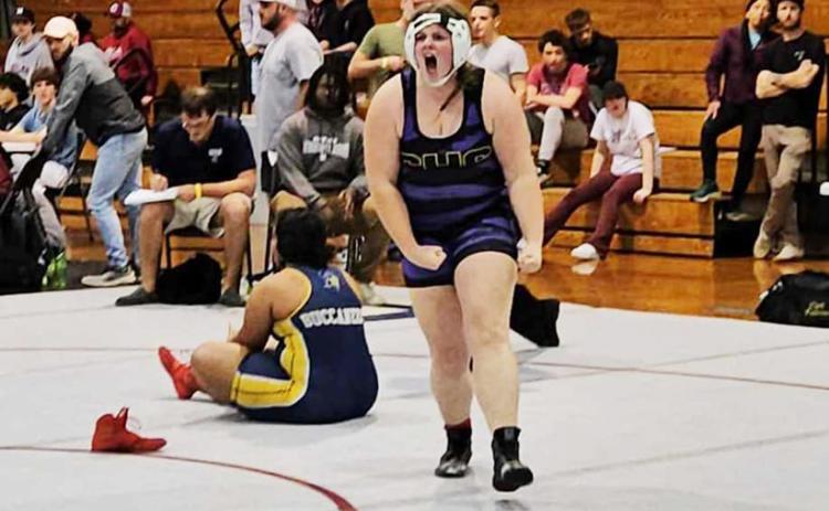 Columbia wrestler Josie Raulerson celebrates after pinning Mainland wrestler Cheyenne Wigley to win the Region 1-1A championship in the 235-pound weight class. (COURTESY)