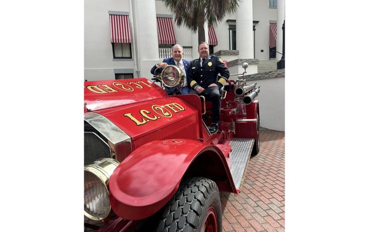 Lake City Fire Chief Josh Wehinger (right) and Florida Chief Financial Officer Jimmy Patronis are pictured atop the LCFD’s antique 1926 fire engine Thursday at the Capitol. (COURTESY)
